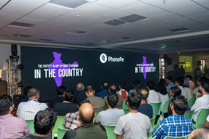 Audience watching a PhonePe presentation on a large LED wall