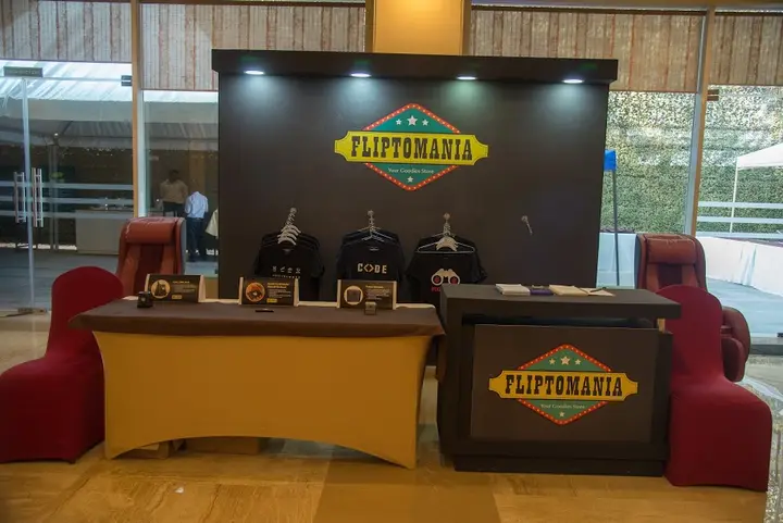 Fliptomania merchandise counter with branded display