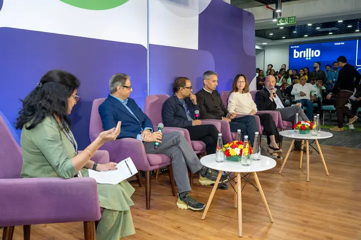 Panel of speakers on lounge chairs at a Brillio event