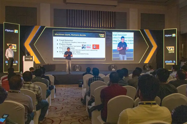 Speaker presenting to a seated audience at a Slash N tech conference