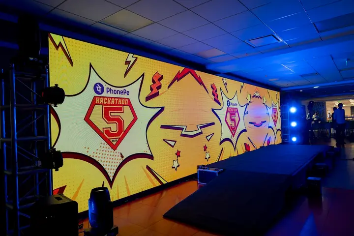 PhonePe Hackathon 5 stage with a comic-book style LED wall