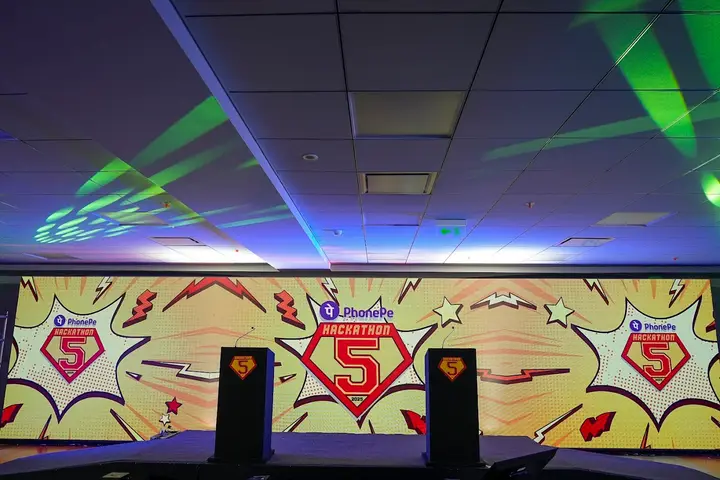PhonePe Hackathon 5 stage with laser lighting and a comic-style LED backdrop